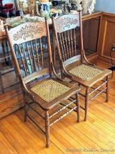 Pair of pressed back chairs with caned seats are both fairly sturdy and in good condition with just