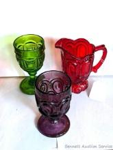 Red glass pitcher and pretty green and purple goblets. All in good condition, red piece about 6-1/2"