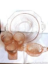 Pink Depression glass pieces incl goblets, bowl, and a sugar dish. A couple chips noted on edge bowl