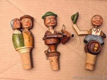 Bottle corks with movable wooden people including kissing couple, fiddle player and man removing his