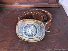 Leather belt with belt buckle stamped German silver has a 1922 silver dollar mounted in the center