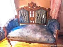 Antique sofa with intricate wood detailing; measures 57" x 24" x 44-1/2" tall.