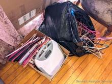 Thinner bathroom scale and plastic hangers galore with just a few wooden and metal hangers mixed in;