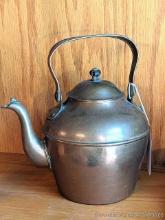 Very nice copper colored tea kettle, measures 9" over handles and is in very nice condition.