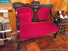 Located upstairs, bring help to remove. Antique loveseat with carved wooden arms, feet, back rest.