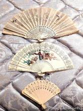 Located upstairs, bring help to remove. Three Oriental ladies fans, largest is 16" at widest. One