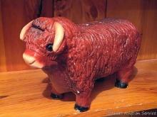 Located upstairs, bring help to remove. Cute bull coin bank is actually rather large - 13" long.
