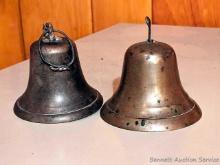 Located upstairs, bring help to remove. Brass toned and other school bell - both ring nicely. Larger