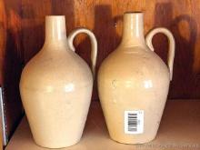 Pair of simple stoneware pitchers are in good condition with just one hairline crack noted near neck