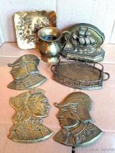 Vintage bronze floral wall hanging plate, small brass or similar pitcher, heavy ship bookend, and