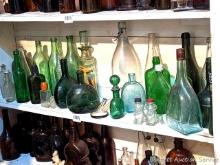 Located in basement, bring help to remove. Collection of wine, beer and liquor bottles up to 14".