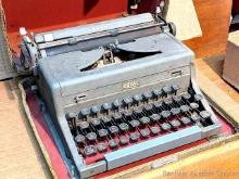 Located in basement, bring help to remove. Vintage Royal Arrow student typewriter with case. Case