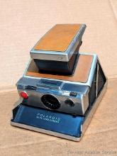 Located in basement, bring help to remove. Retro Polaroid SX-70 Land Camera looks like it's in very