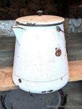 Located in basement, bring help to remove. Huge old enameled coffee pot like the logging camps used