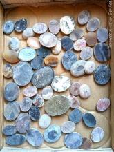 Variety of cut rocks waiting to be shaped, polished and set into jewelry for the next craft fair.