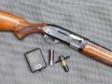 Remington Model 1100 semi-automatic 12 gauge shotgun. The 30" barrel has a clean, mirror bore,