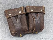 Military ammunition belt pouches are leather with dual clips, brass and steel hardware. The pouches
