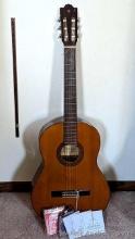 Yamaha G-230 acoustic guitar comes with extra strings, measures 40" overall.