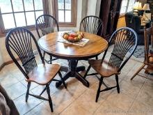 Farmhouse style 44" diameter table with 4 chairs, 20" wide leaf and a pretty center piece. Made in