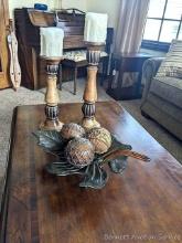 Leaf and ornate balls table decoration with tall wood-like candle holders