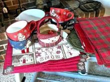 Four sets of Christmas placemats, plus a set of four snowman mugs that would be great for soup; a