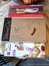 Hamilton Beach electric knife, Pampered Chef cookie press and Wilton dessert decorator plus; all are