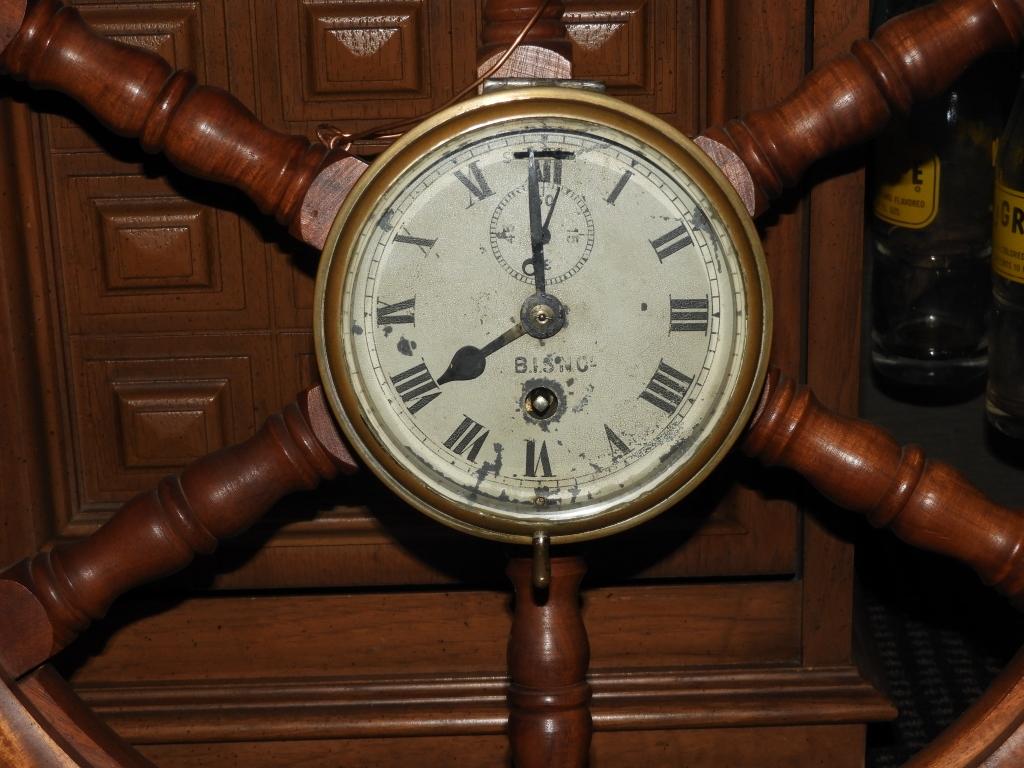 Ships wheel clock marked Bisn Company, 28"x27"