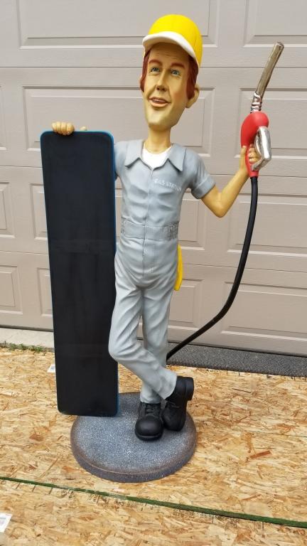 Gas station attendant with chalkboard, lifesize