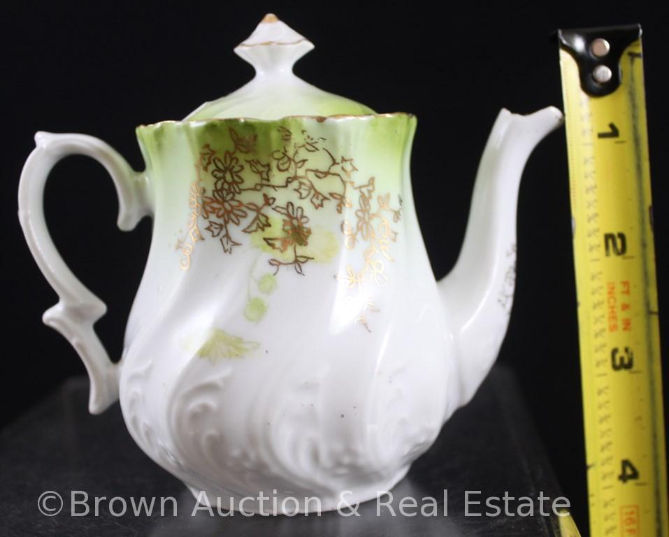 Unm. Child's set: 4.25"h teapot, 2.25"h creamer and open sugar, green floral d?cor on white swirl