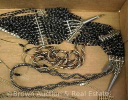 Box lot of costume jewelry incl. necklaces and brooches, lots of black and some animal pieces