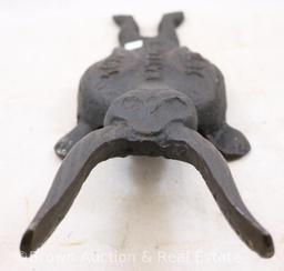 (2) Cast Iron book jacks: 9.5"l cricket and 12"l "Watergate, 1973/1976"