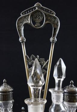 Rockford Silverplate castor set with 5 matching bottles, holder has floral decorated rim and