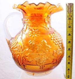 Carnival Glass Dugan Floral and Grape 9" water pitcher, marigold