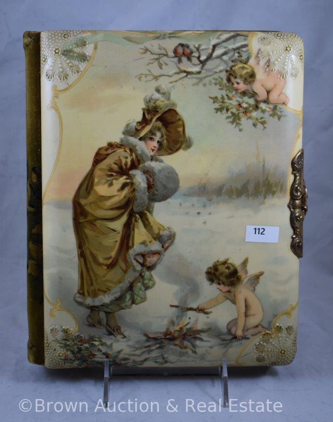 Vintage photo album with celluloid cover featuring winter scene/woman and cherubs, artist signed