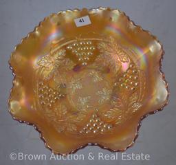 Carnival Glass Grape and Cable 8"d bowl with spatula feet, marigold