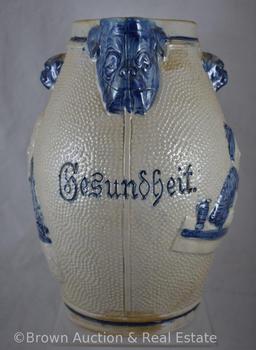 Stoneware salt glazed 11"h beer pitcher with embossed people and dog heads, "Gesundheit"