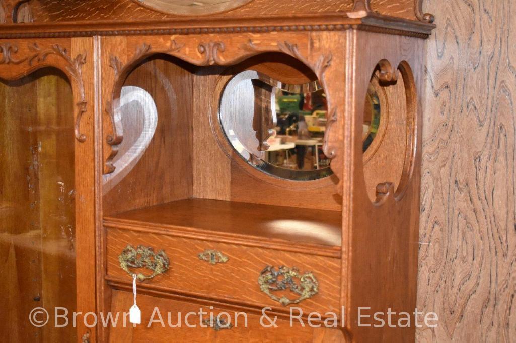 Oak secretary/bookcase combo with hooded drop-front lid desk, other drawers for storage, carved