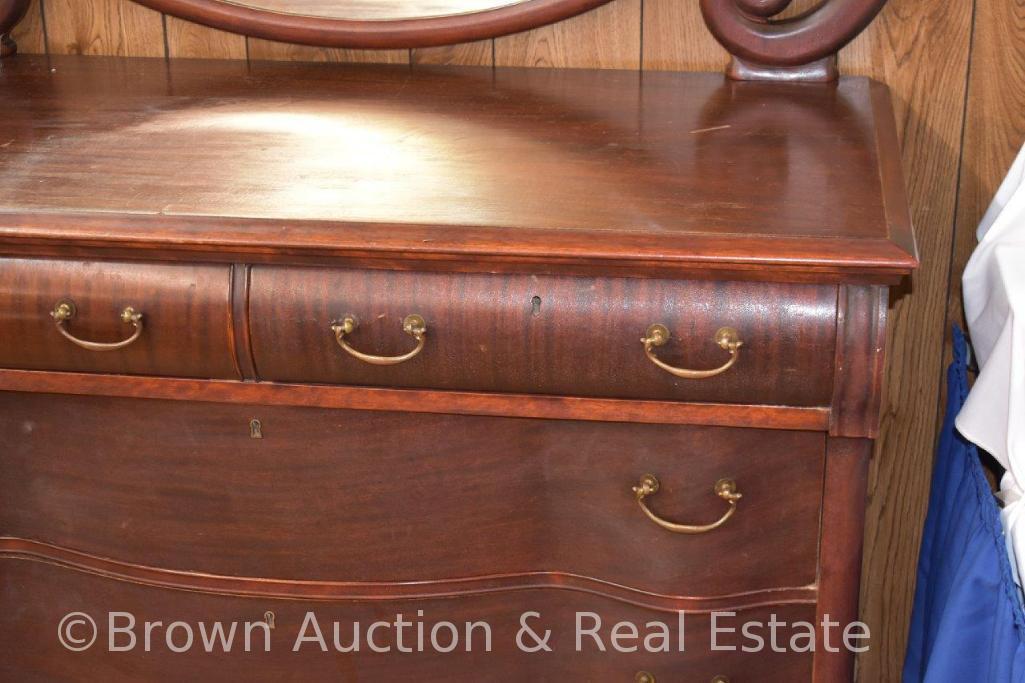 Dresser with top roller drawers and 2 serpentine lower drawers, large oval beveled swing mirror