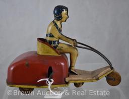 Tin wind-up toy - girl in 2 pc. swimsuit driving 3-wheel cart - wants to work