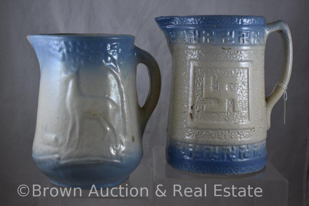 (2) Blue and white Stoneware pitchers, 8.5"h (both have hairlines): Swastika/Indian Good Luck and