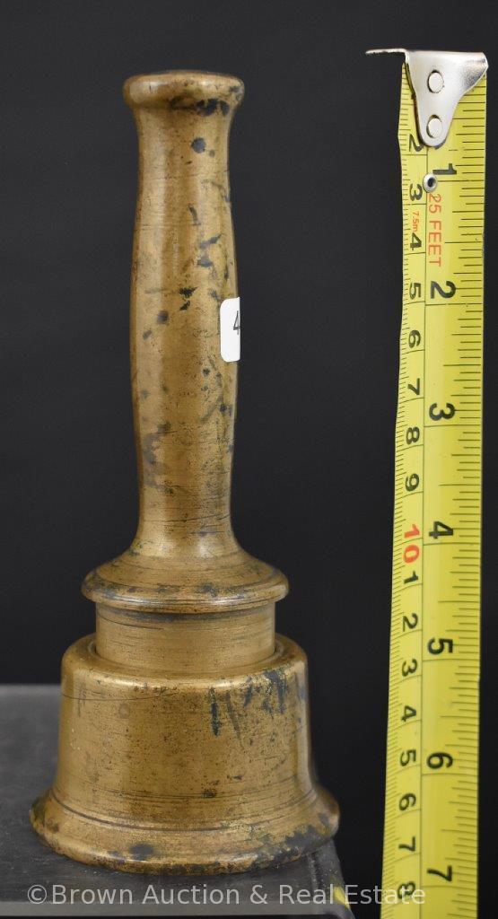 Solid brass pestle of some sorts with holder