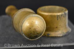 Solid brass pestle of some sorts with holder