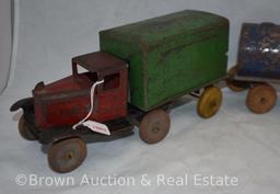 Vintage pressed steel truck with detachable cargo trailer pulling oil/water tank