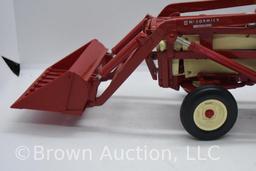 International 460 die-cast tractor with McCormick front-end loader, rear blade, tire chains and