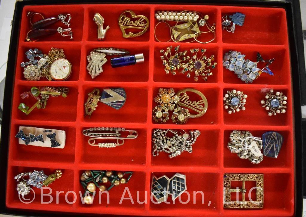 Assortment of jewelry: necklaces, earrings, brooches, belt buckle