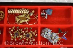 Assortment of jewelry: necklaces, earrings, brooches, belt buckle