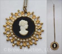 Vintage lady cameo necklace on black background framed by pearl-like stones and gold filigree