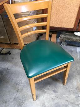 Dining chairs with green padded seats