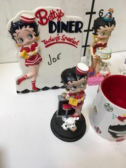 Collectible Betty Boop figurines, salt and pepper shakers, coffee cup, etc