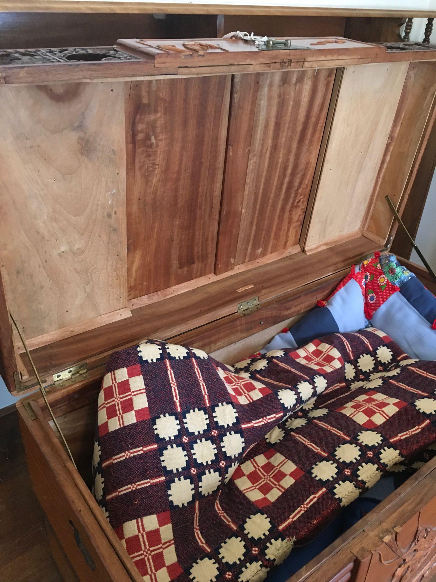 Hand carved, vintage Oriental chest with metal accents & (3) blankets/quilts